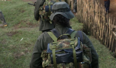 Colombia, 2010: Mountains in the Valle del Cauca region, between Santander de Quilichao et Popayan. FARC-EP (Revolutionary Armed Forces of Colombia) combattants walking next to native houses. 